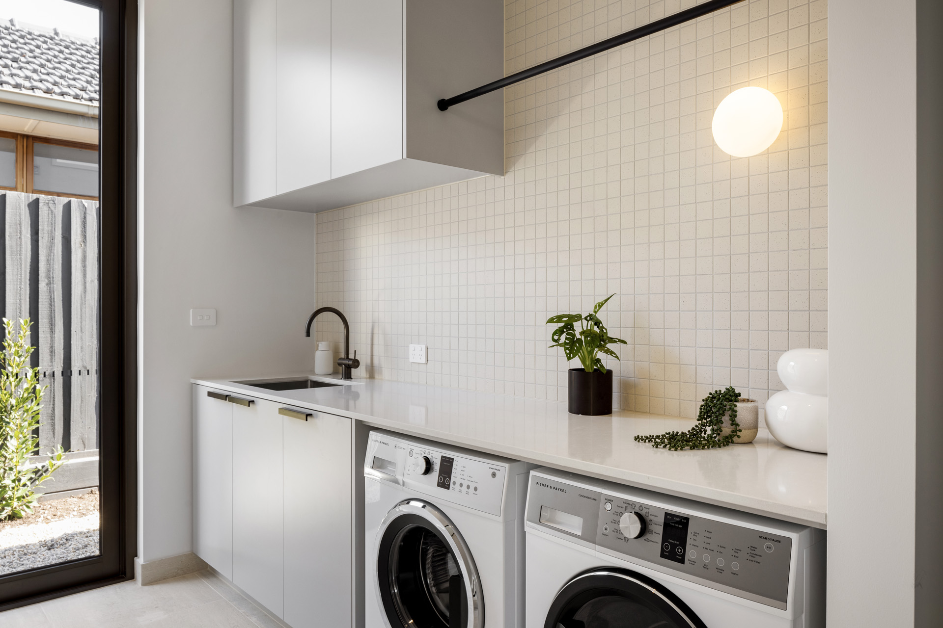 laundry area featuring 2 washing machines